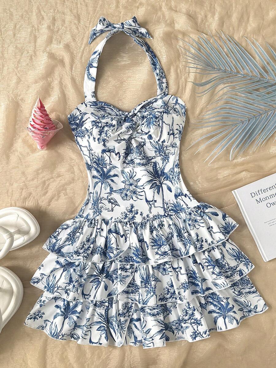 Tween girls blue and white floral halter sundress with shirred detail, sleeveless cami style, high waist, and tiered ruffle hem for vacation wear