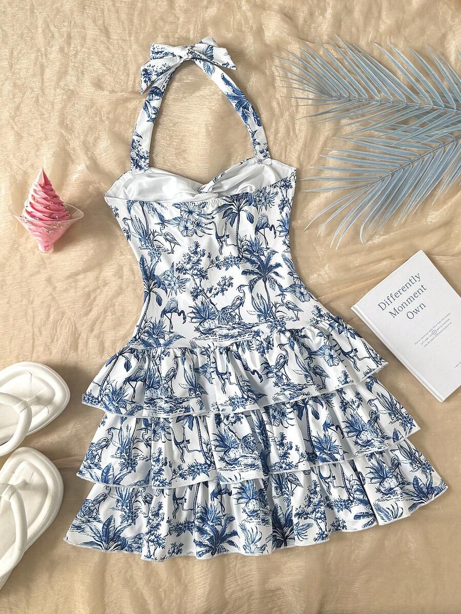 Tween girls blue and white floral halter sundress with shirred detail, sleeveless cami style, high waist, and tiered ruffle hem for vacation wear