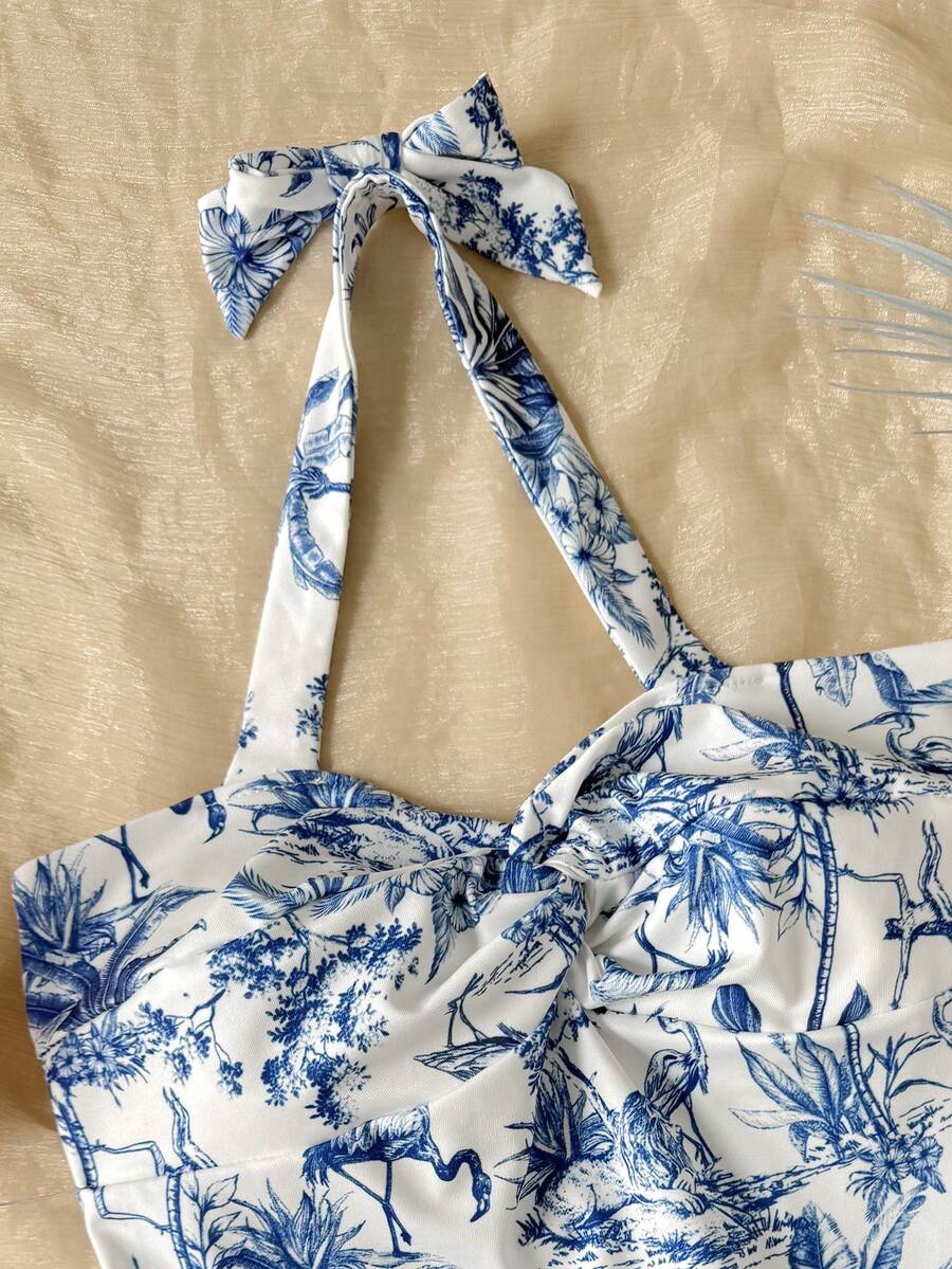 Tween girls blue and white floral halter sundress with shirred detail, sleeveless cami style, high waist, and tiered ruffle hem for vacation wear