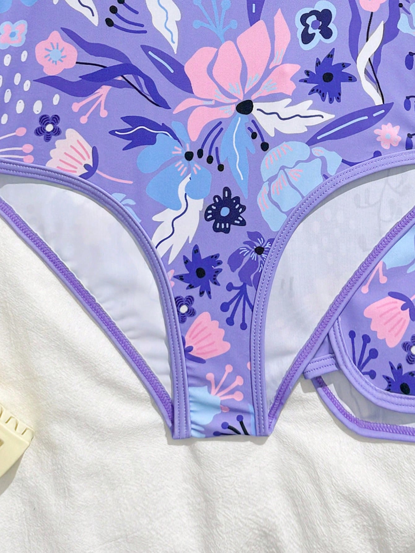Girls 2-piece swimwear set featuring a butterfly print halter swimsuit top with contrast piping and separate mid-waist shorts; sleeveless, high-stretch, wireless design for beach and vacation wear.