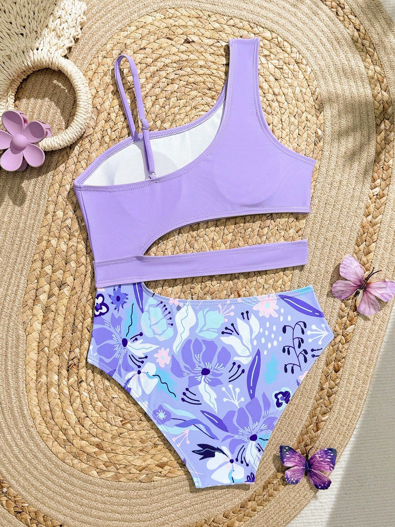 Purple tween girls one-piece swimsuit with asymmetrical neckline, cut-out waist, striped pattern, fitted silhouette, and lined body.