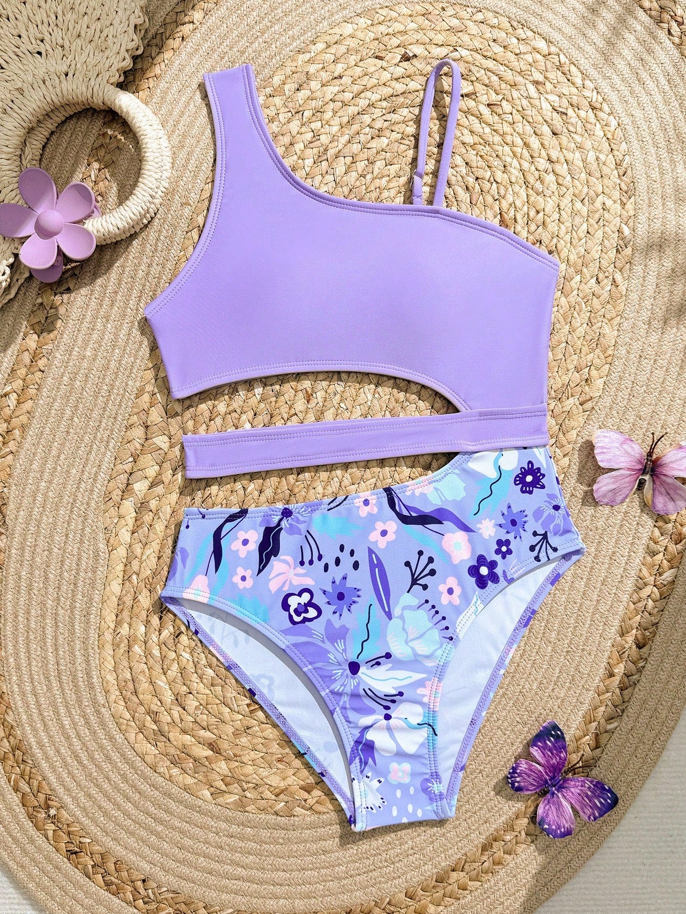 Purple tween girls one-piece swimsuit with asymmetrical neckline, cut-out waist, striped pattern, fitted silhouette, and lined body.