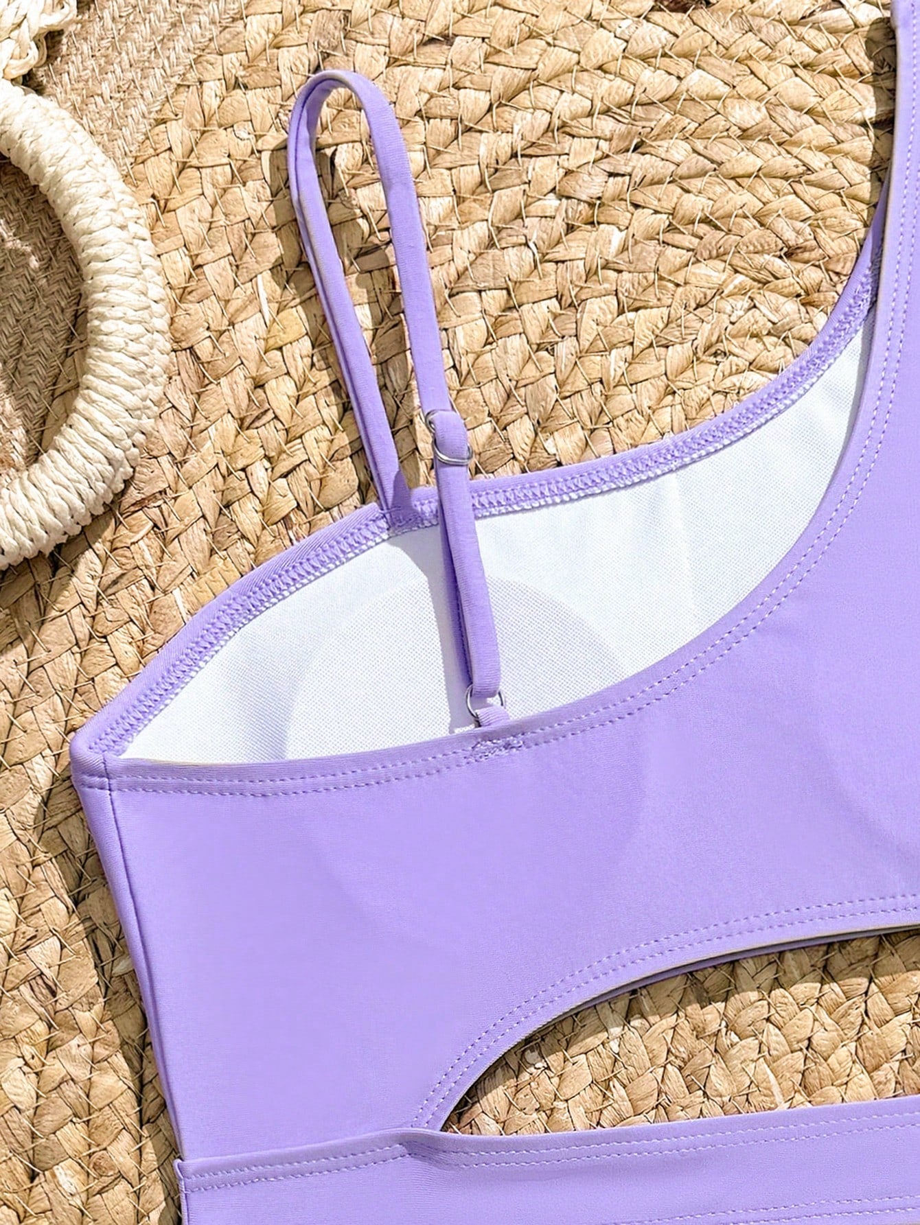Purple tween girls one-piece swimsuit with asymmetrical neckline, cut-out waist, striped pattern, fitted silhouette, and lined body.