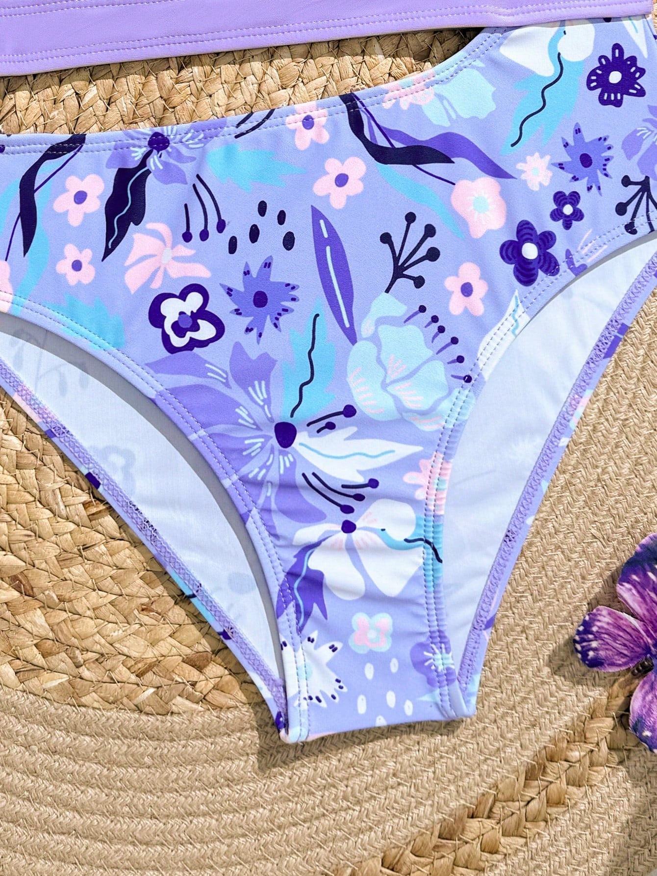 Purple tween girls one-piece swimsuit with asymmetrical neckline, cut-out waist, striped pattern, fitted silhouette, and lined body.