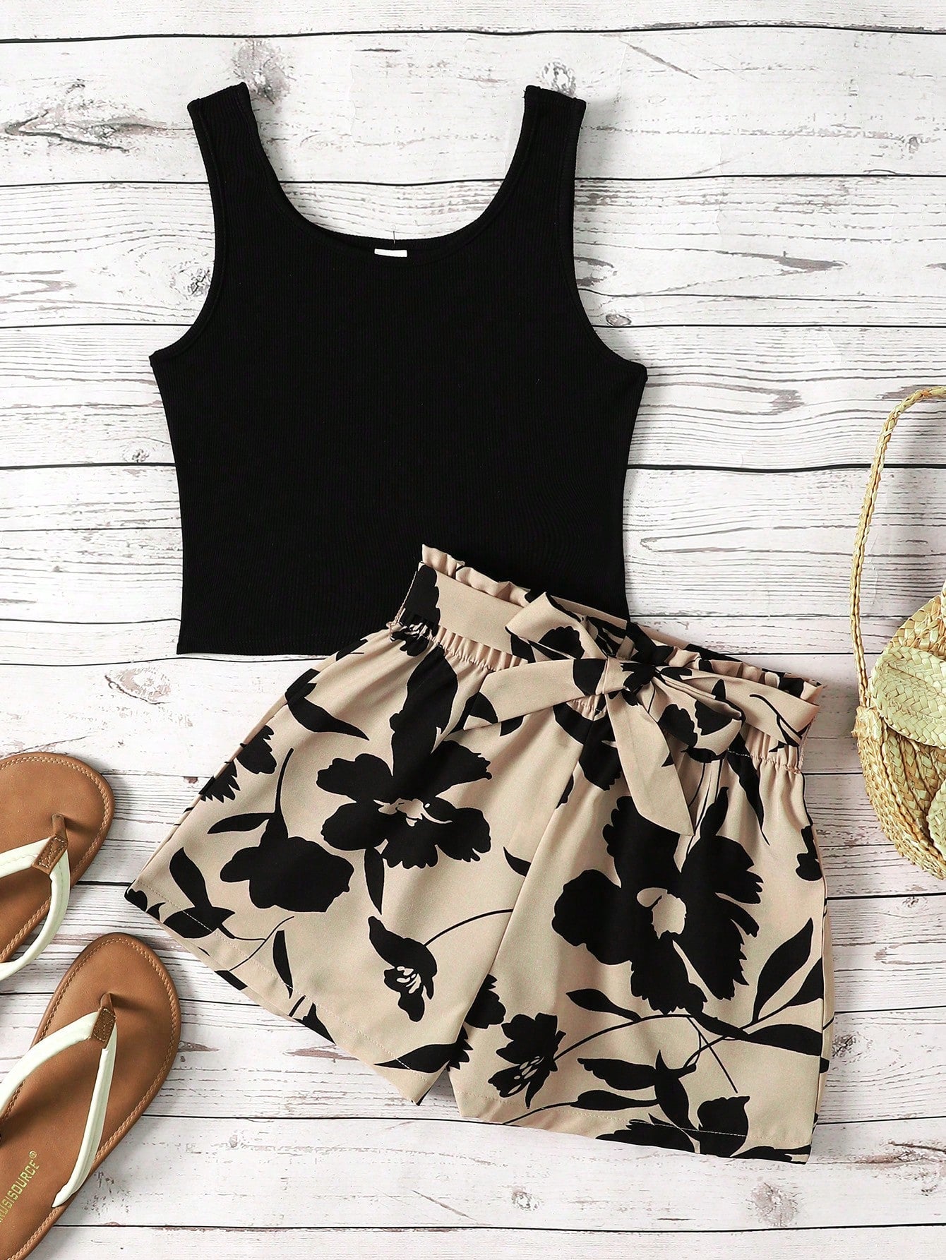 Tween girl wearing a casual 2-piece set featuring a black rib-knit scoop neck tank top and leopard print paperbag waist shorts with a matching belt.