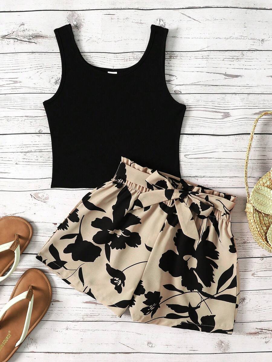 Tween girl wearing a casual 2-piece set featuring a black rib-knit scoop neck tank top and leopard print paperbag waist shorts with a matching belt.