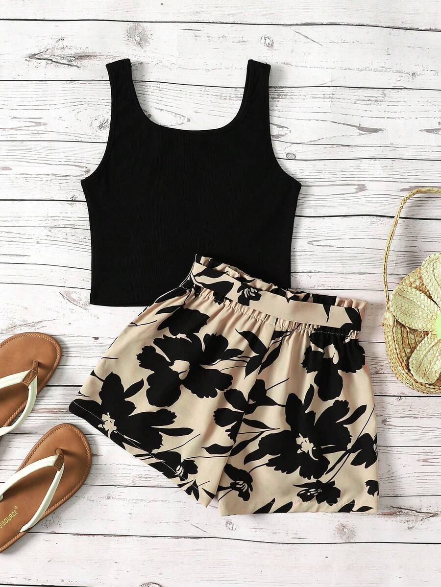 Tween girl wearing a casual 2-piece set featuring a black rib-knit scoop neck tank top and leopard print paperbag waist shorts with a matching belt.