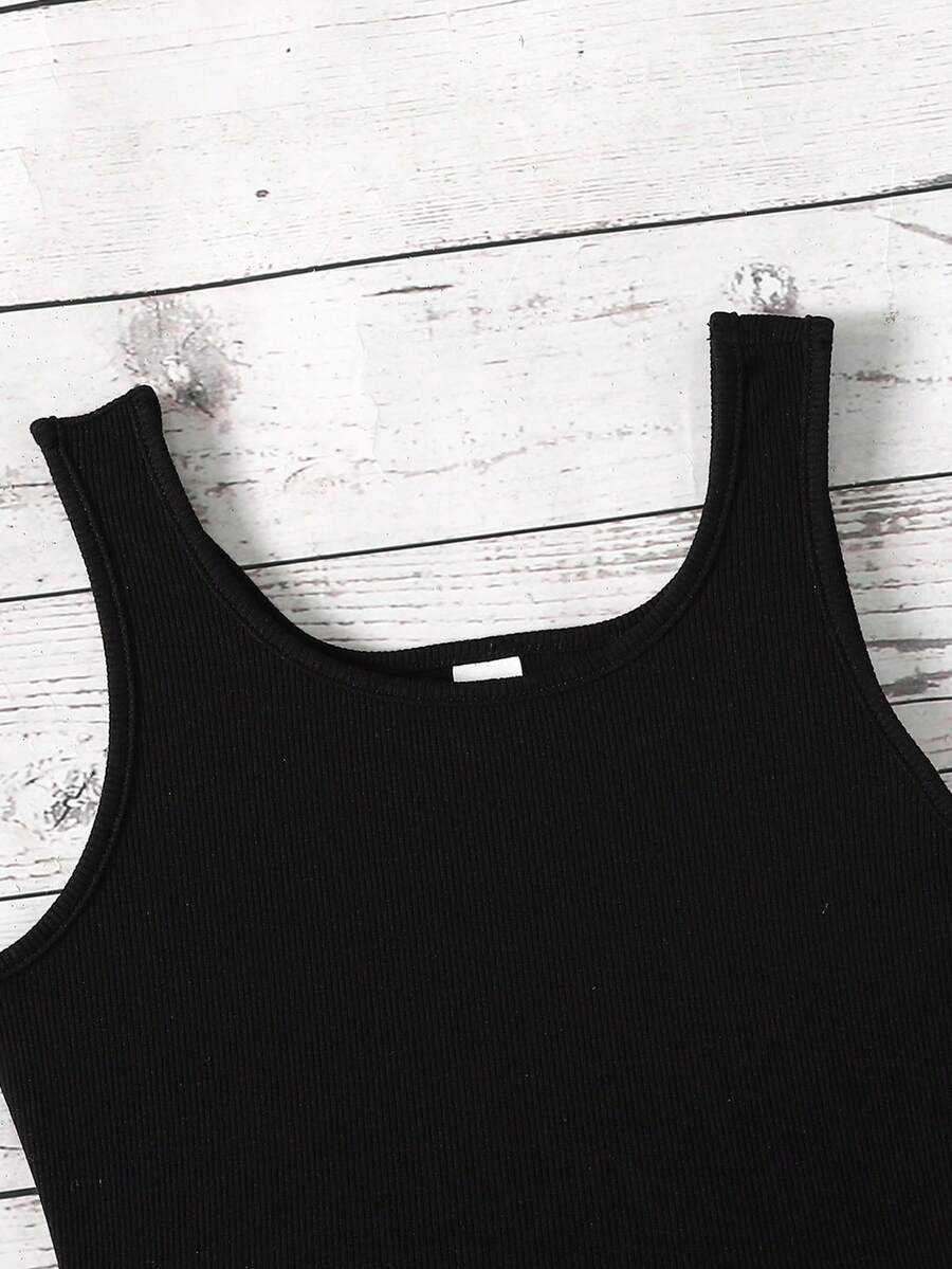 Tween girl wearing a casual 2-piece set featuring a black rib-knit scoop neck tank top and leopard print paperbag waist shorts with a matching belt.
