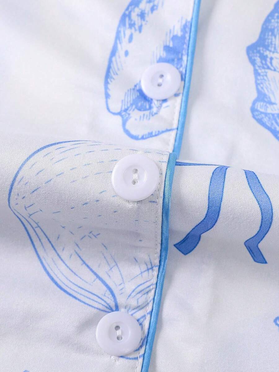 White 2-piece tween girl summer pajama set with blue ocean and seashell print featuring a short sleeve lapel cardigan top and matching elastic waist shorts.