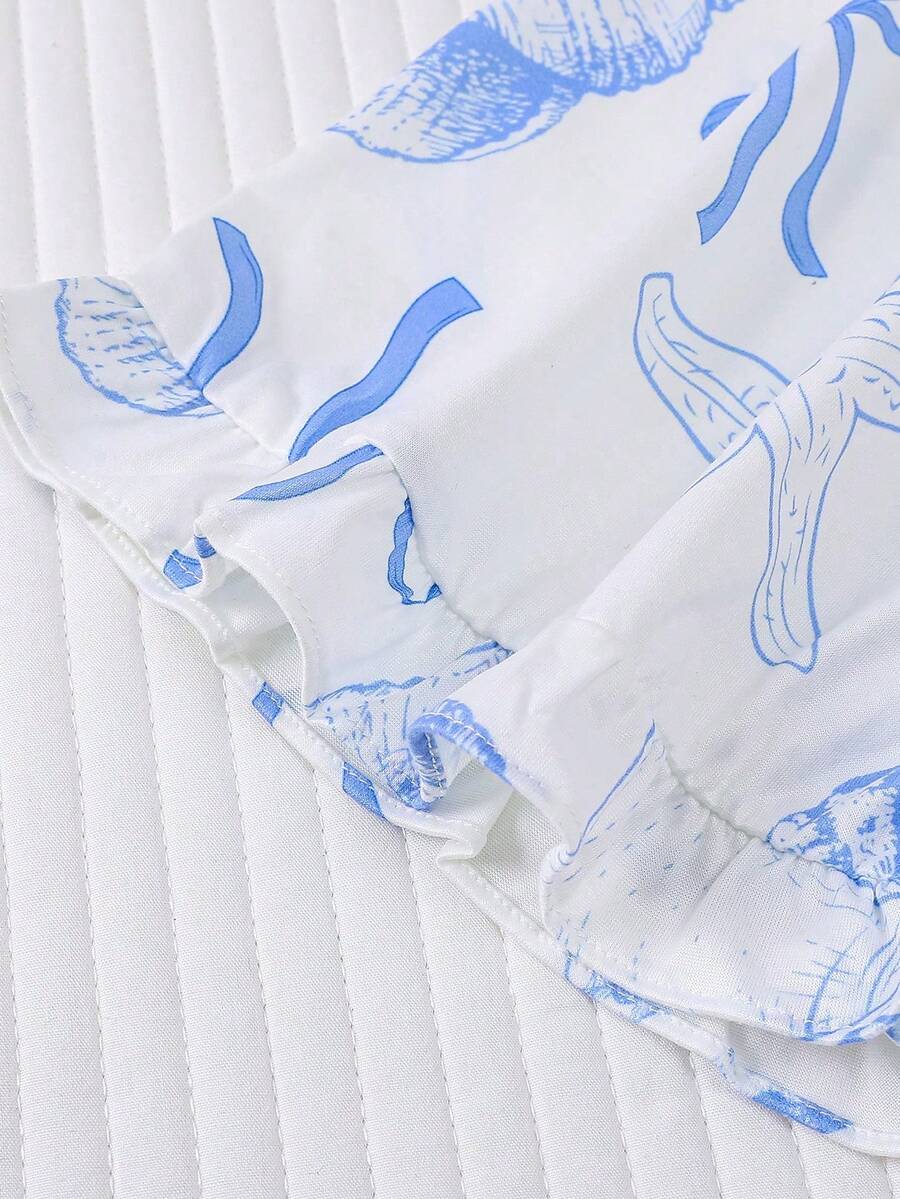 White 2-piece tween girl summer pajama set with blue ocean and seashell print featuring a short sleeve lapel cardigan top and matching elastic waist shorts.