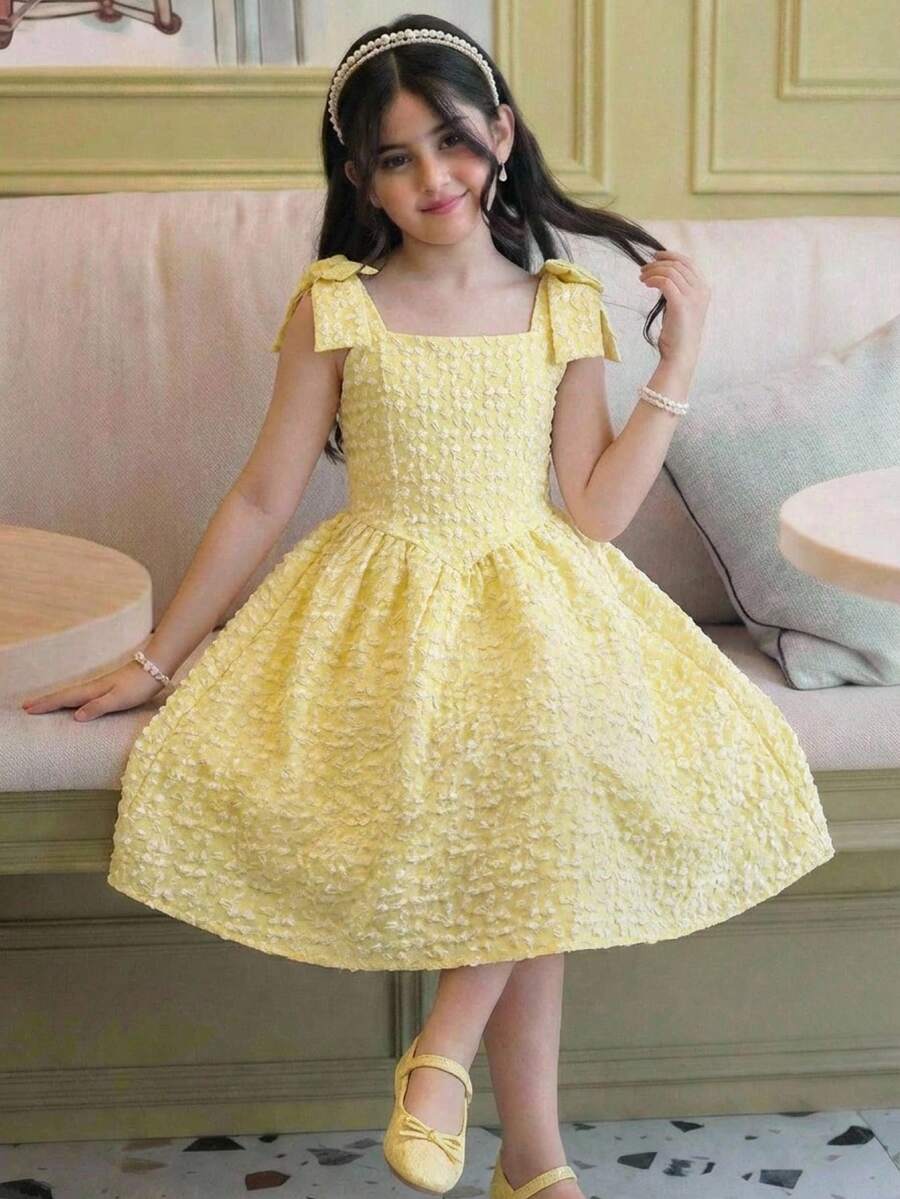 Yellow floral sleeveless A-line dress for tween girls featuring high waist, shirred detailing, and decorative bow