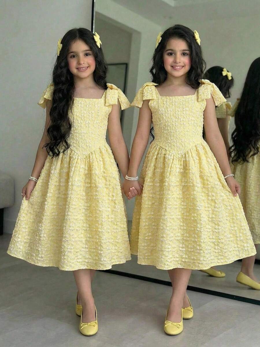 Yellow floral sleeveless A-line dress for tween girls featuring high waist, shirred detailing, and decorative bow