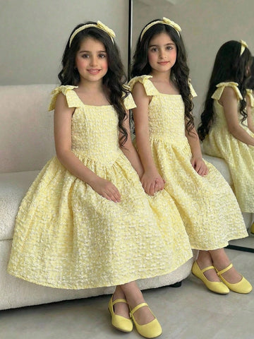 Yellow floral sleeveless A-line dress for tween girls featuring high waist, shirred detailing, and decorative bow