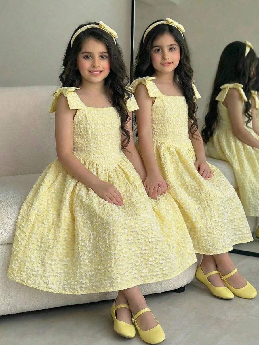 Yellow floral sleeveless A-line dress for tween girls featuring high waist, shirred detailing, and decorative bow