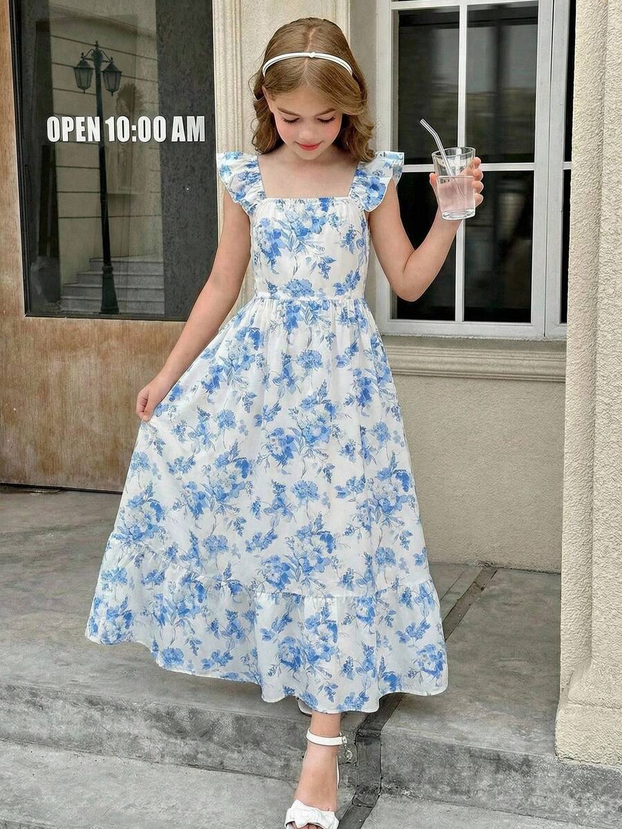 Blue floral print long vacation dress for tween girls featuring an A-line high waist silhouette with ruffle details and spaghetti straps.