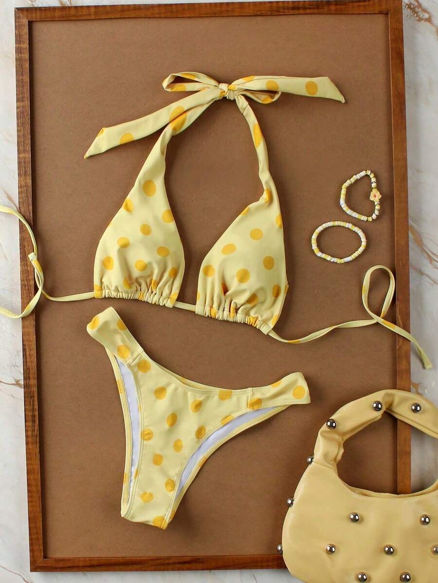 Women's halter neck bikini swimwear set featuring a wireless bra top with removable padding and mid waist bikini bottom.