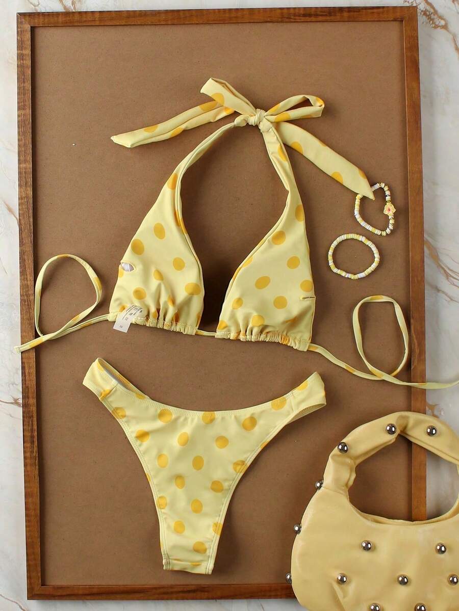 Women's halter neck bikini swimwear set featuring a wireless bra top with removable padding and mid waist bikini bottom.