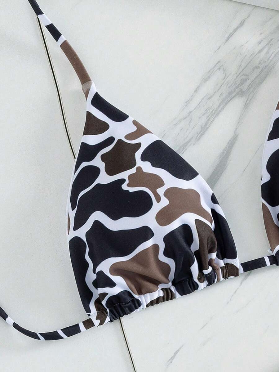 Women's two-piece black bikini set showing a halter triangle tie-back top and matching side-tie bikini bottoms.