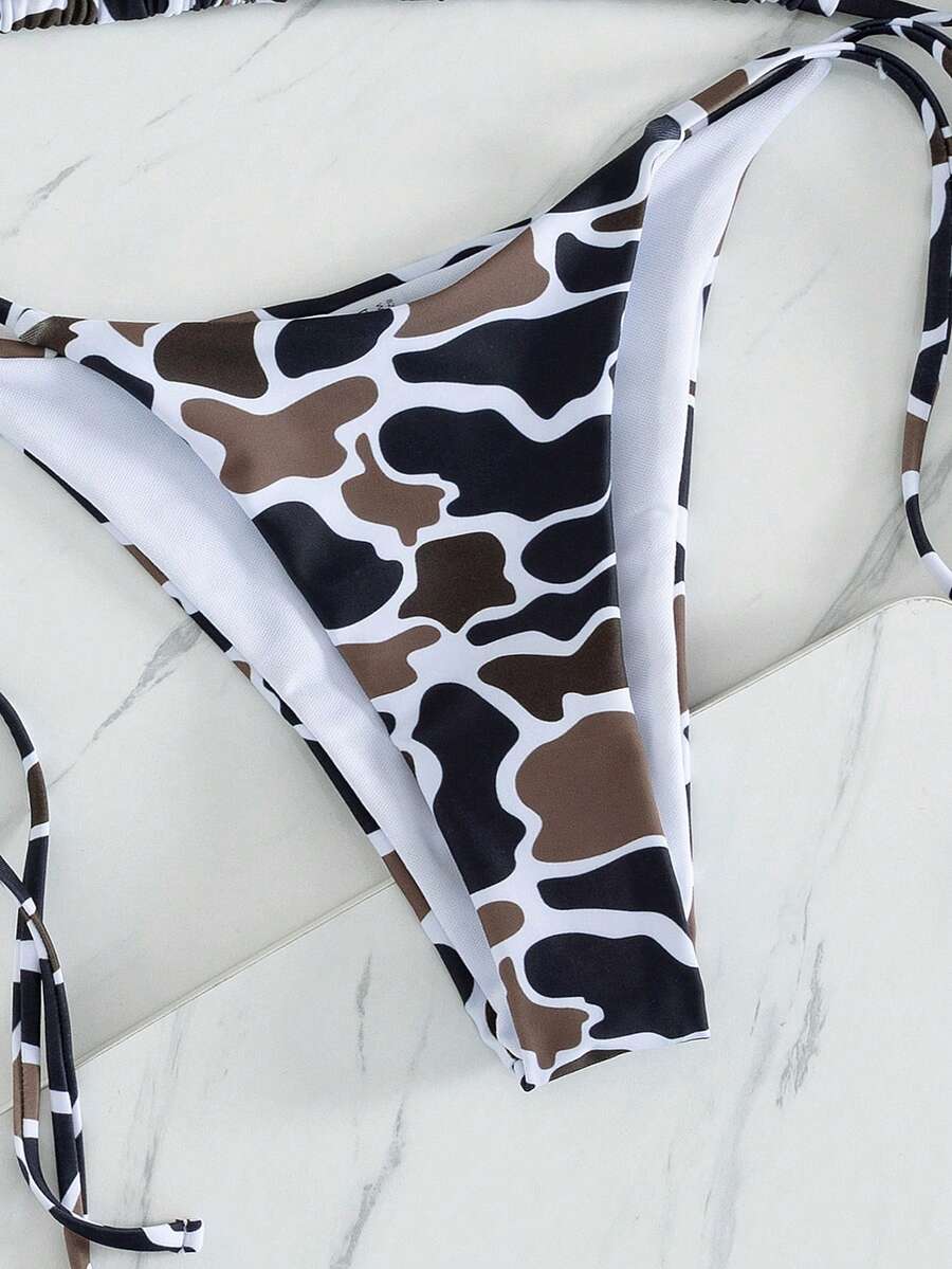Women's two-piece black bikini set showing a halter triangle tie-back top and matching side-tie bikini bottoms.
