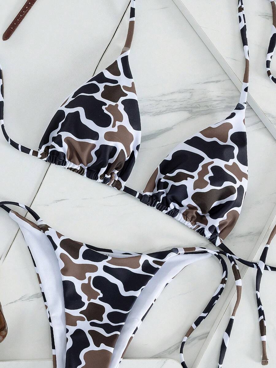 Women's two-piece black bikini set showing a halter triangle tie-back top and matching side-tie bikini bottoms.