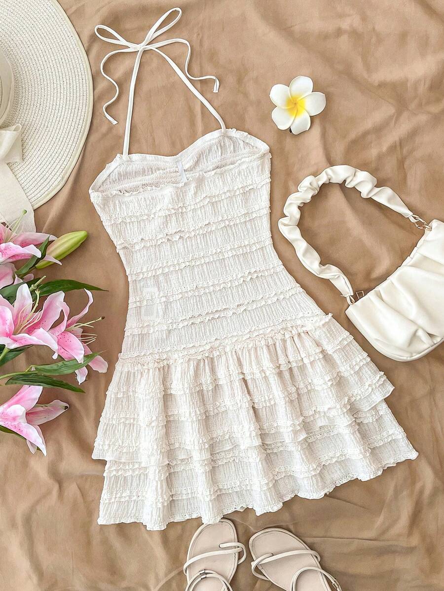 White tween girl sleeveless halter mini dress with asymmetrical tiered ruffle hem, high waist, zipper detail, and A-line slim fit