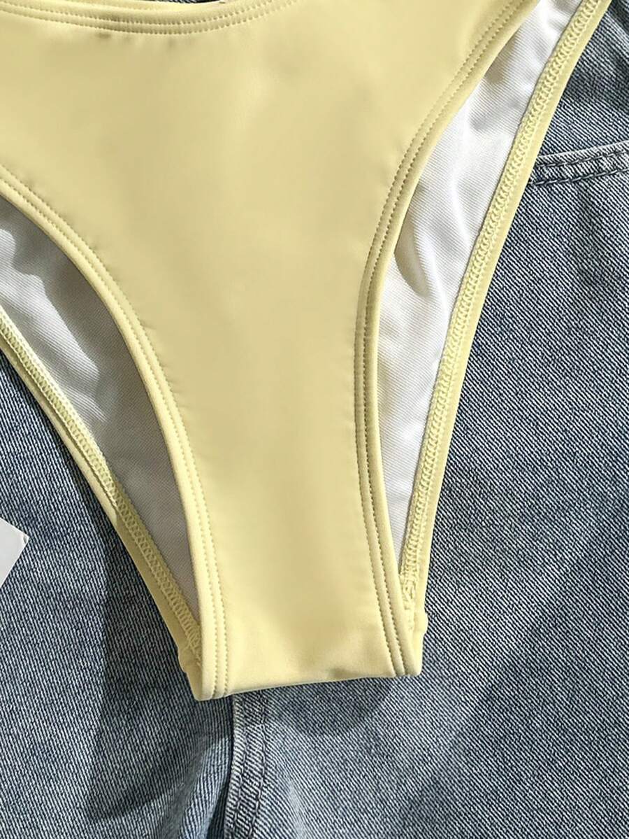 Apricot ribbed high waist two piece bikini swimsuit set for women featuring backless spaghetti strap top and high waisted bottoms.