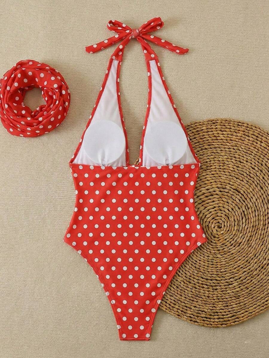 Women's apricot polka dot two-piece swimsuit featuring an asymmetrical halter backless top with knot tie detail and high-waisted bottoms.