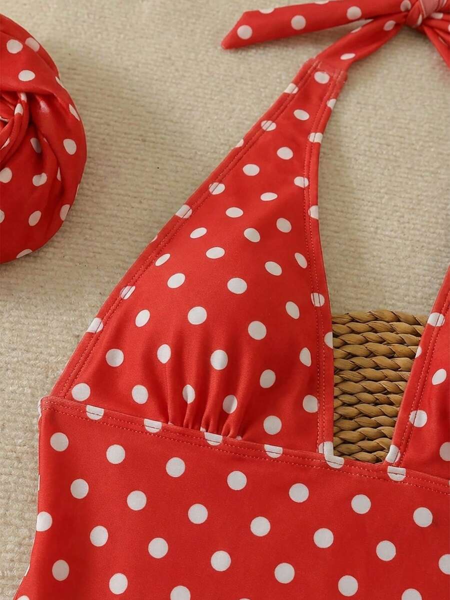 Women's apricot polka dot two-piece swimsuit featuring an asymmetrical halter backless top with knot tie detail and high-waisted bottoms.