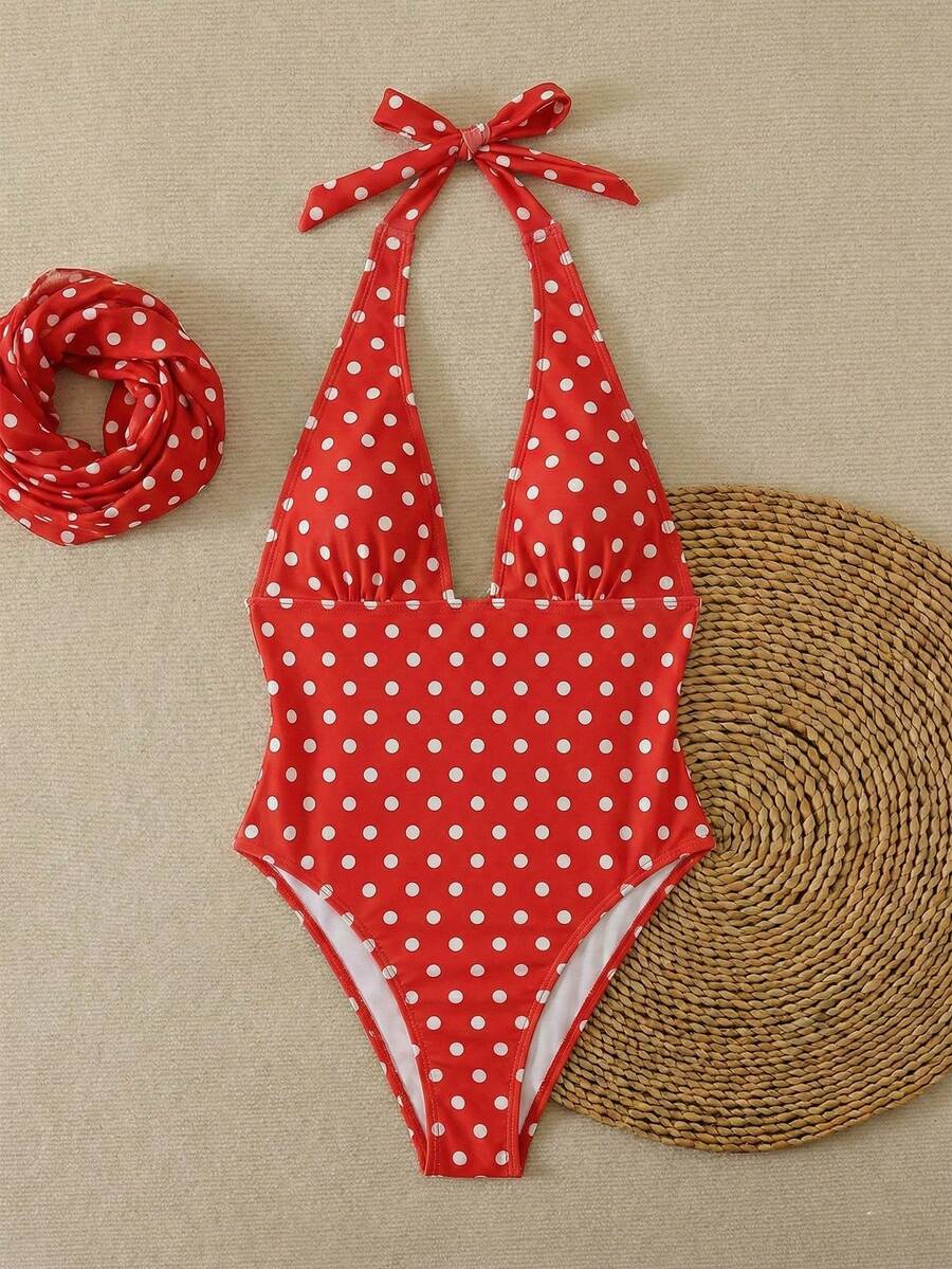 Women's apricot polka dot two-piece swimsuit featuring an asymmetrical halter backless top with knot tie detail and high-waisted bottoms.