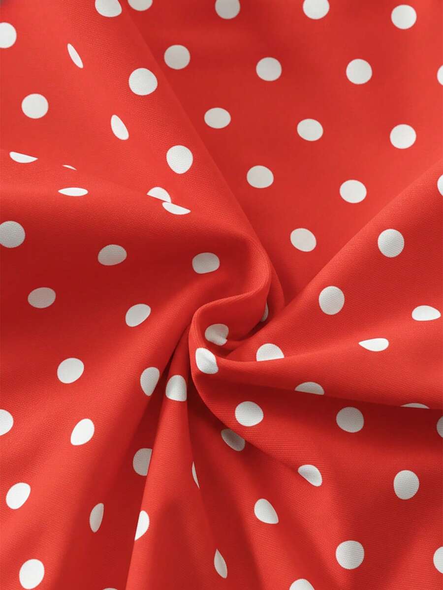 Women's apricot polka dot two-piece swimsuit featuring an asymmetrical halter backless top with knot tie detail and high-waisted bottoms.