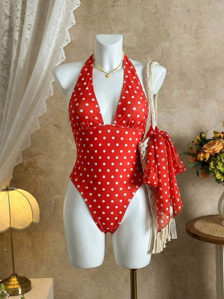 Women's apricot polka dot two-piece swimsuit featuring an asymmetrical halter backless top with knot tie detail and high-waisted bottoms.