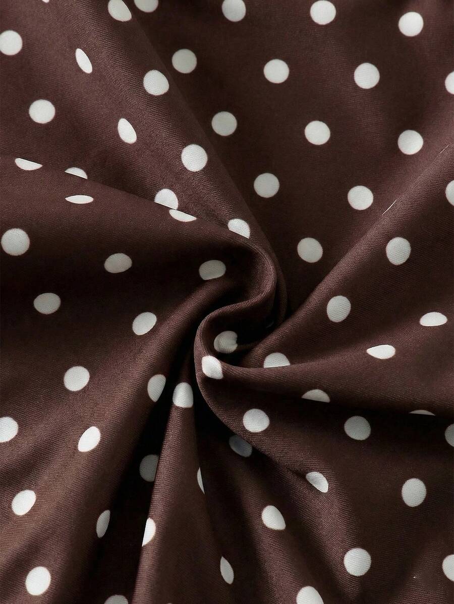 Women's apricot polka dot two-piece swimsuit featuring an asymmetrical halter backless top with knot tie detail and high-waisted bottoms.