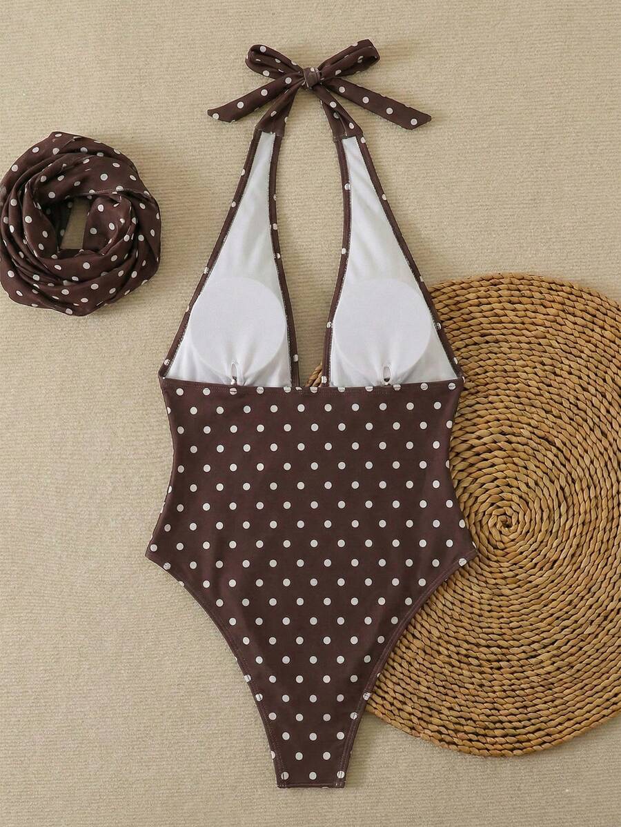 Women's apricot polka dot two-piece swimsuit featuring an asymmetrical halter backless top with knot tie detail and high-waisted bottoms.