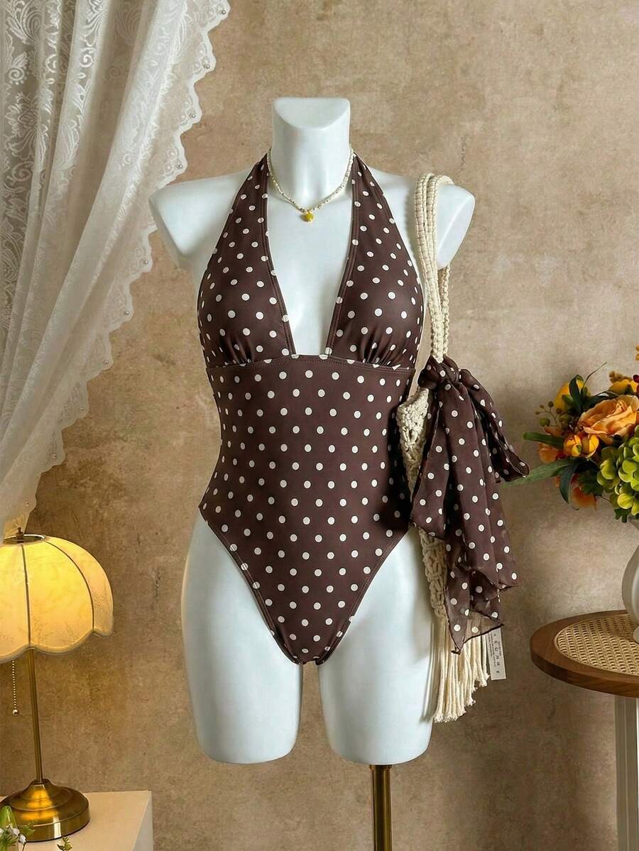 Women's apricot polka dot two-piece swimsuit featuring an asymmetrical halter backless top with knot tie detail and high-waisted bottoms.