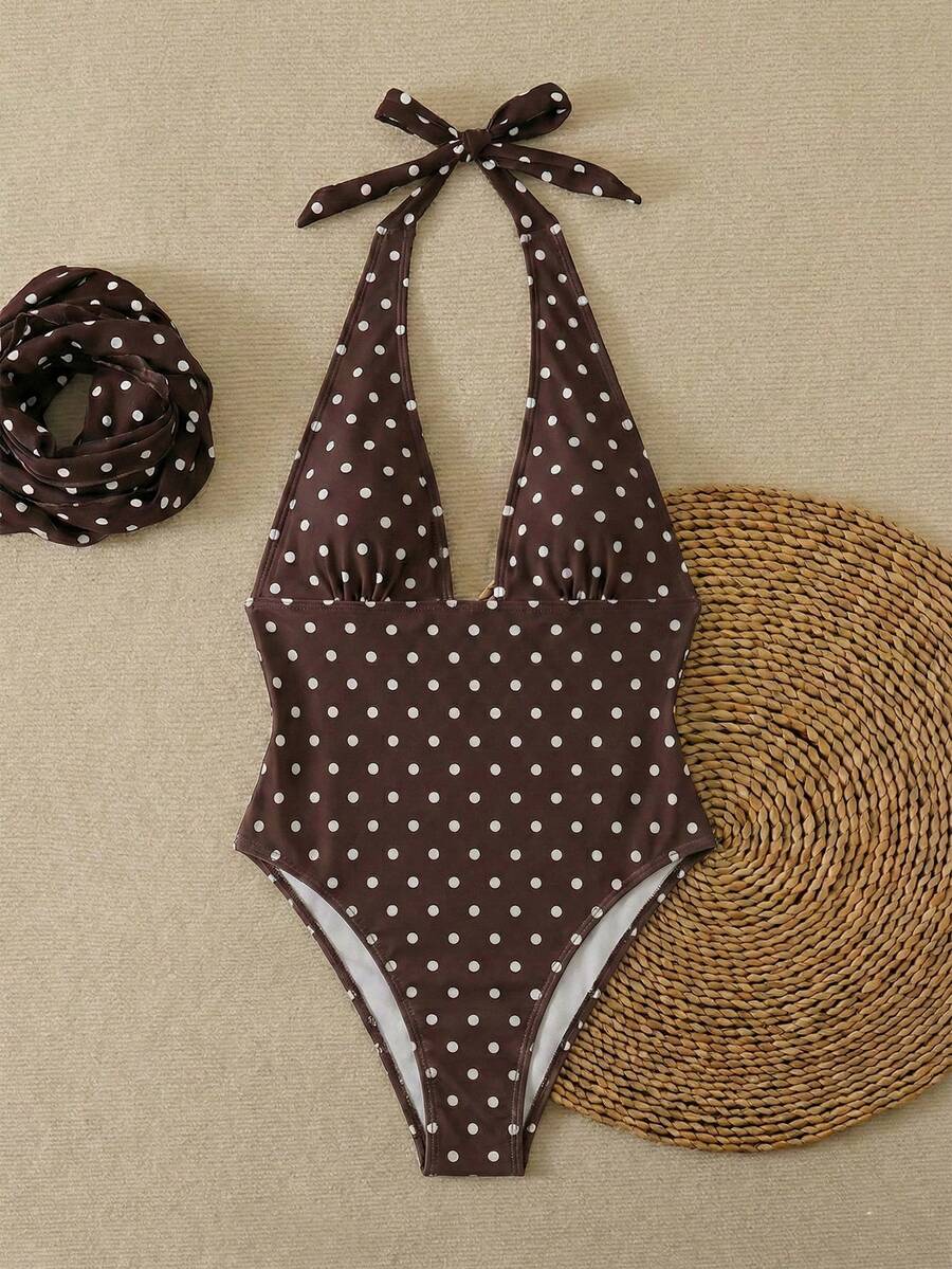 Women's apricot polka dot two-piece swimsuit featuring an asymmetrical halter backless top with knot tie detail and high-waisted bottoms.