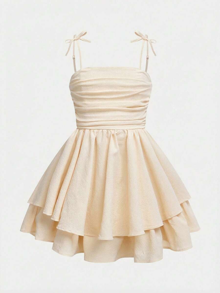 Tween girls apricot tiered cami dress with spaghetti straps, high waist, and slim fit layered hem.