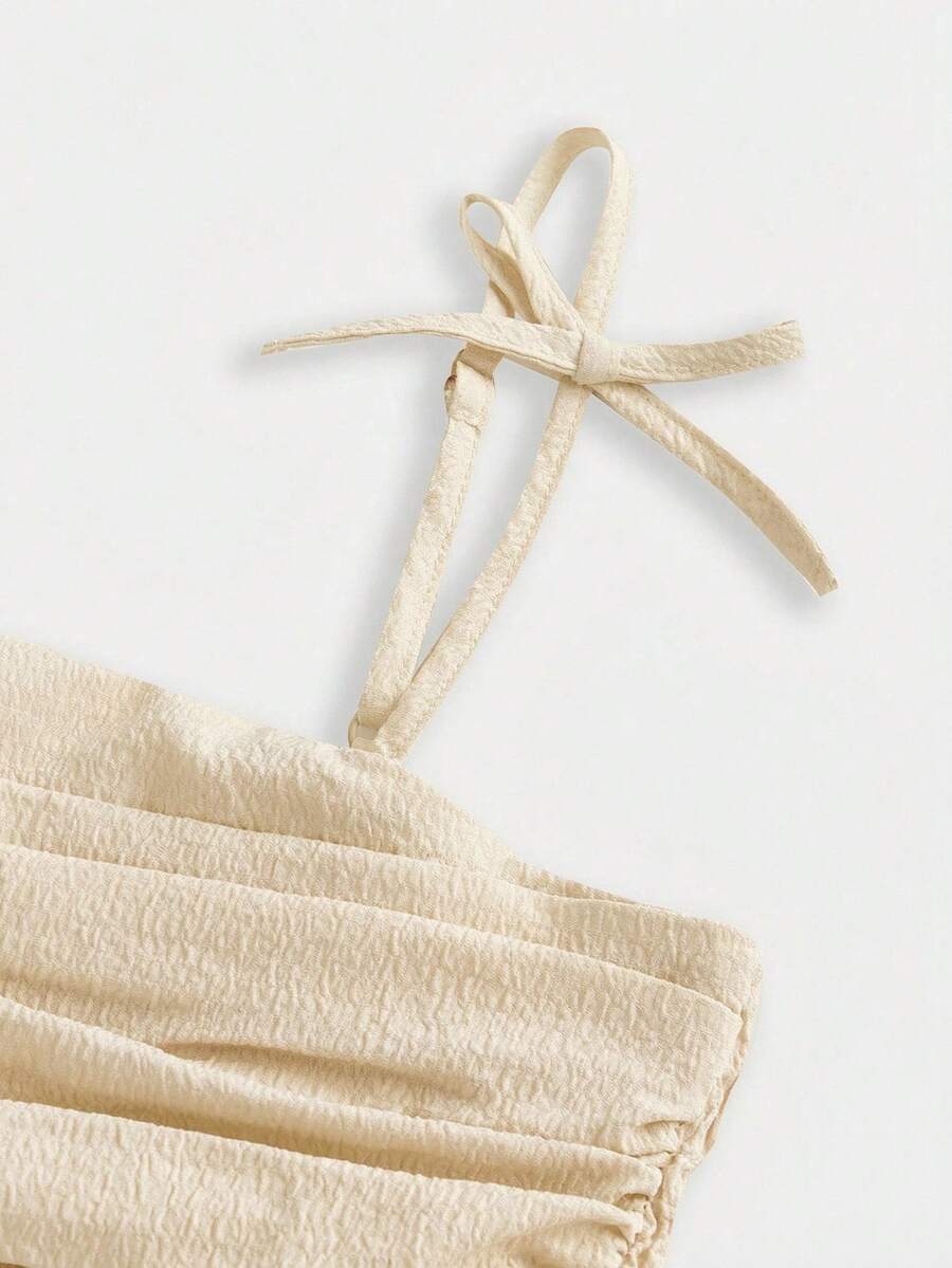 Tween girls apricot tiered cami dress with spaghetti straps, high waist, and slim fit layered hem.