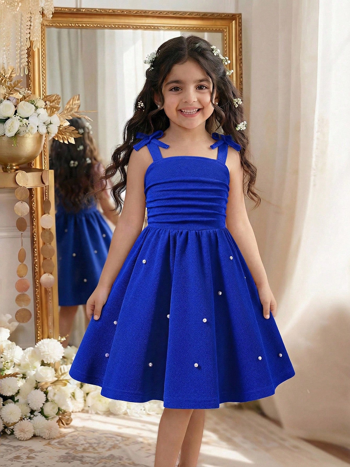 Tween girl wearing a purple sleeveless striped cami mini dress featuring a high waist flared hem and beaded pearl details.