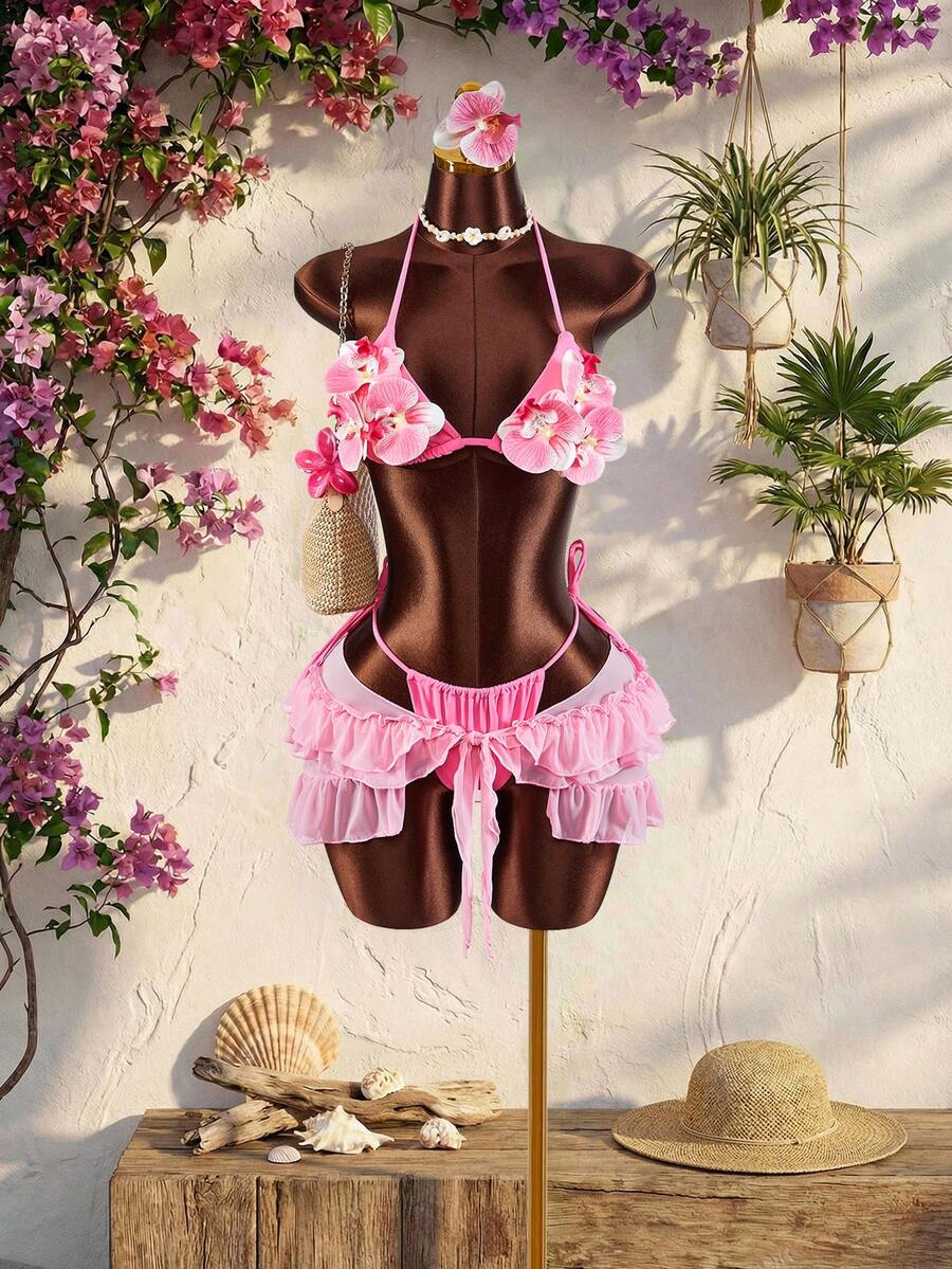 Women's 3-piece blue bikini swimwear set featuring a crop top with 3D rose accents, tie back detail, spaghetti straps, and tie-side bottoms.