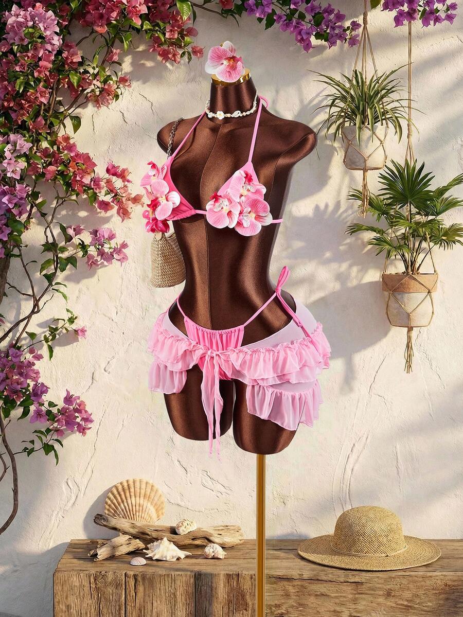 Women's 3-piece blue bikini swimwear set featuring a crop top with 3D rose accents, tie back detail, spaghetti straps, and tie-side bottoms.