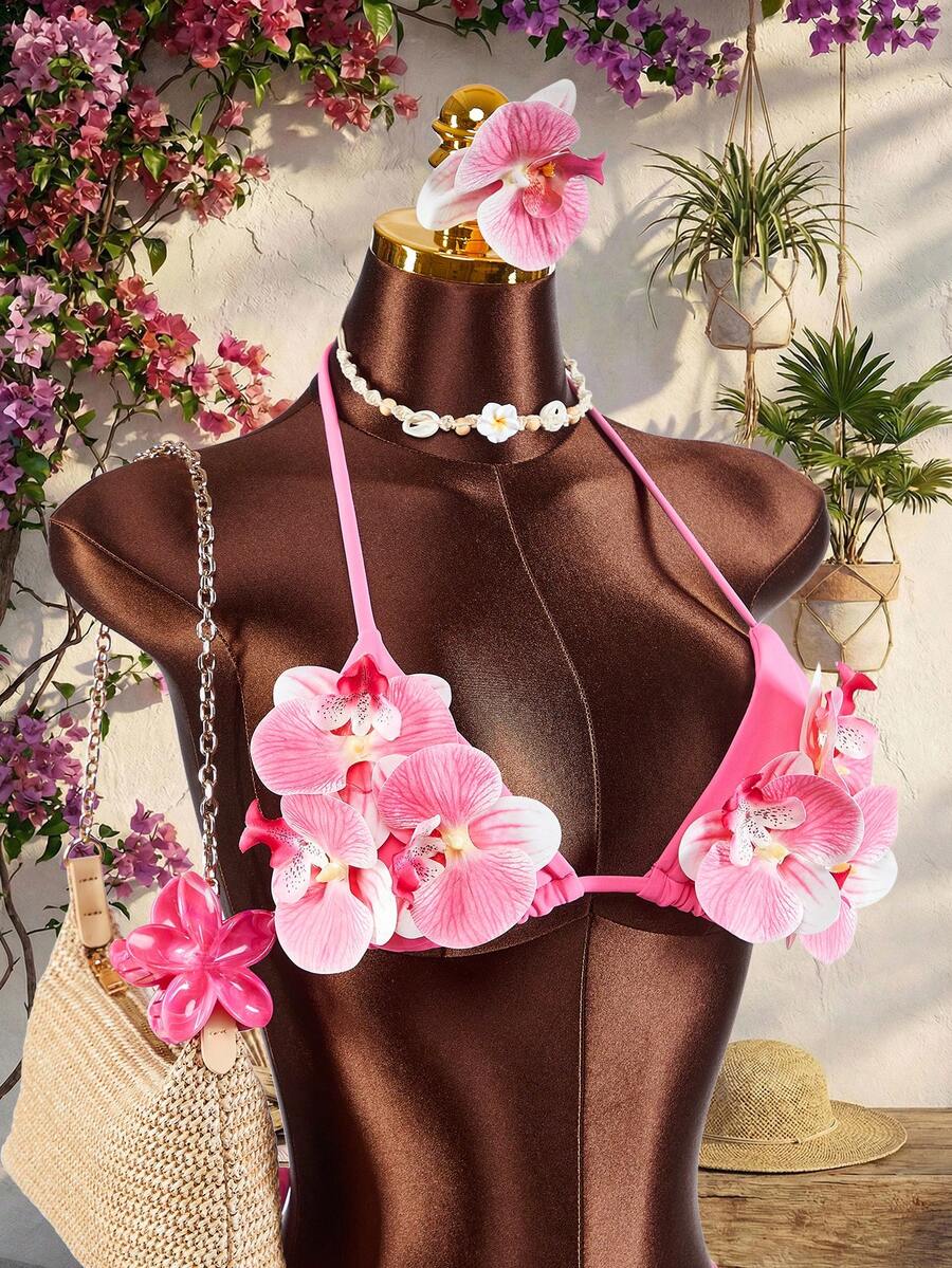 Women's 3-piece blue bikini swimwear set featuring a crop top with 3D rose accents, tie back detail, spaghetti straps, and tie-side bottoms.