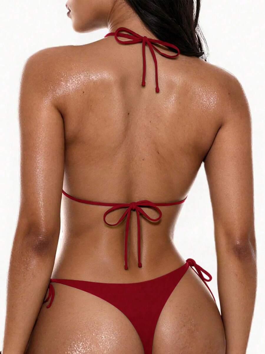Women's halter neck bikini swimwear set featuring a wireless backless top and low-waist tie-side thong bottoms.