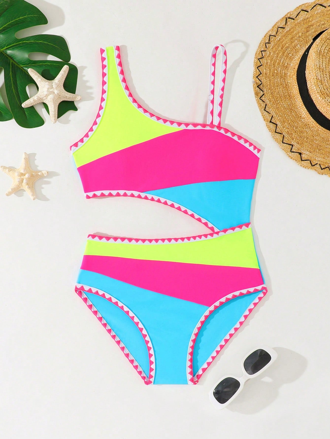 Tween girls one-piece swimsuit featuring an asymmetric neckline, pendant decor, plain design, wireless bra, high-cut bottom, and medium-stretch fabric.