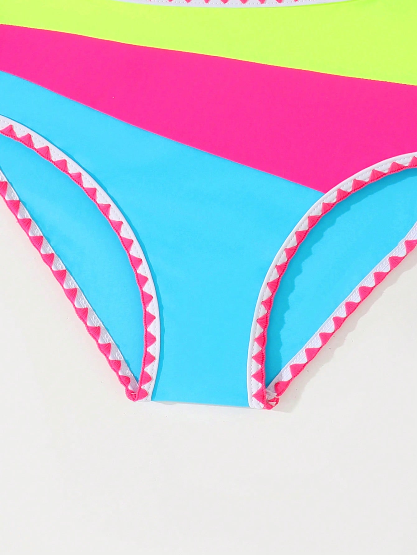 Tween girls one-piece swimsuit featuring an asymmetric neckline, pendant decor, plain design, wireless bra, high-cut bottom, and medium-stretch fabric.