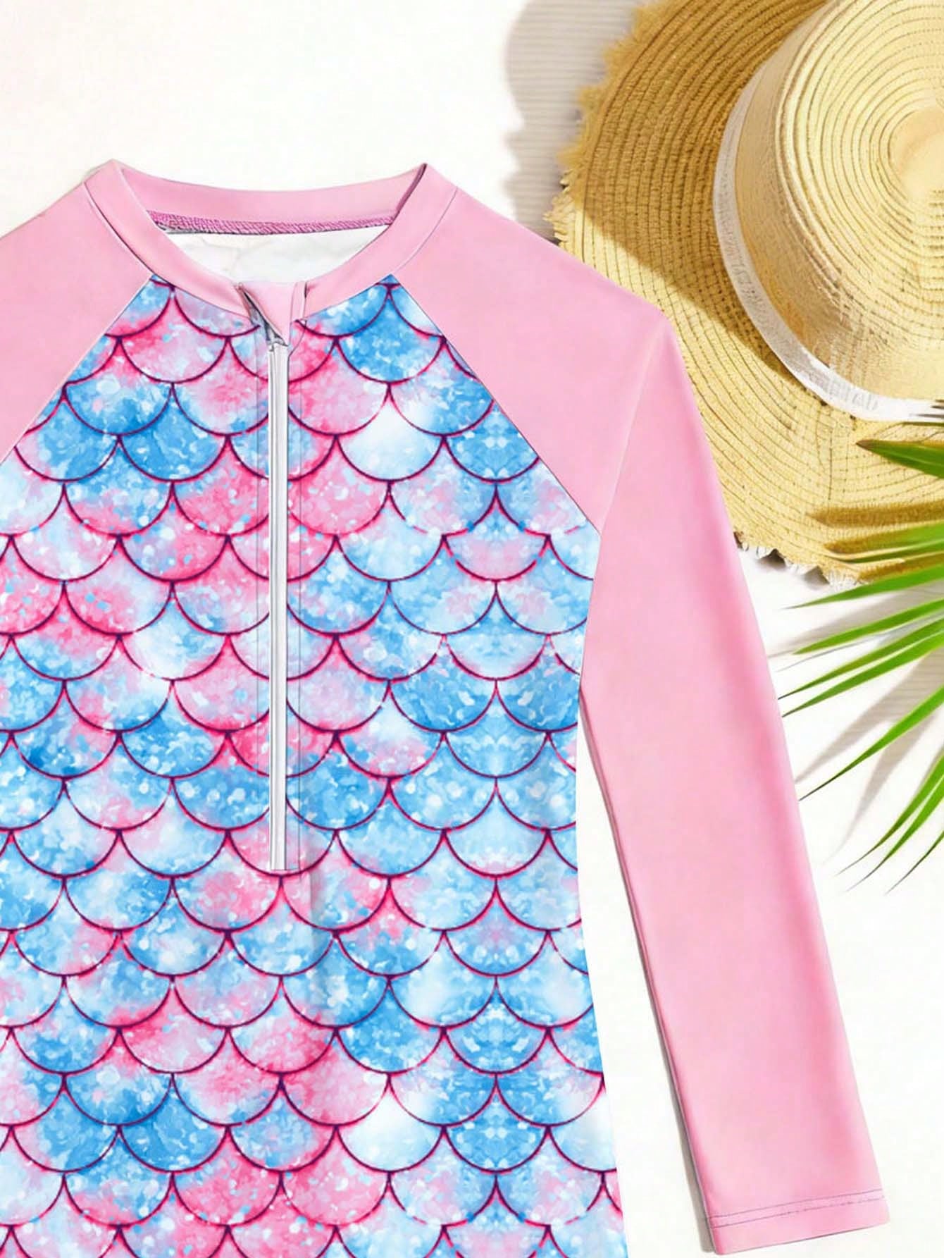 Tween girls one-piece swimsuit featuring a high neck, long sleeves, and shorts bottom, with a back zipper and strawberry plaid digital print on stretch knit fabric. Designed for swimming, vacation, and summer wear.