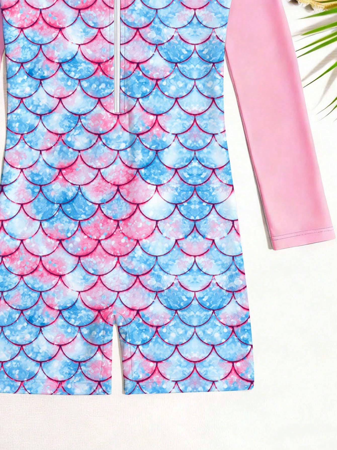 Tween girls one-piece swimsuit featuring a high neck, long sleeves, and shorts bottom, with a back zipper and strawberry plaid digital print on stretch knit fabric. Designed for swimming, vacation, and summer wear.