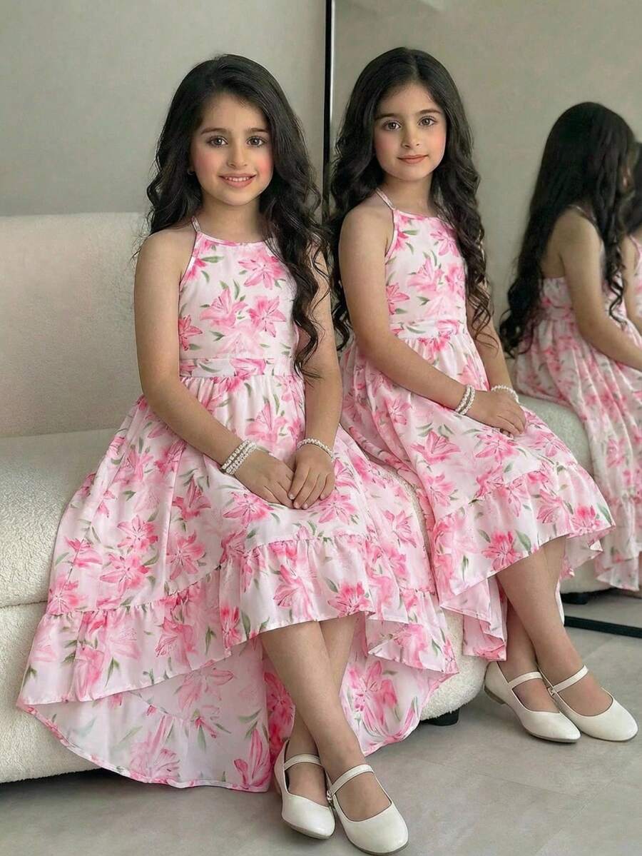 Pink floral print asymmetrical cami dress for tween girls featuring a high waist, sleeveless design, halter neckline, and back zipper.