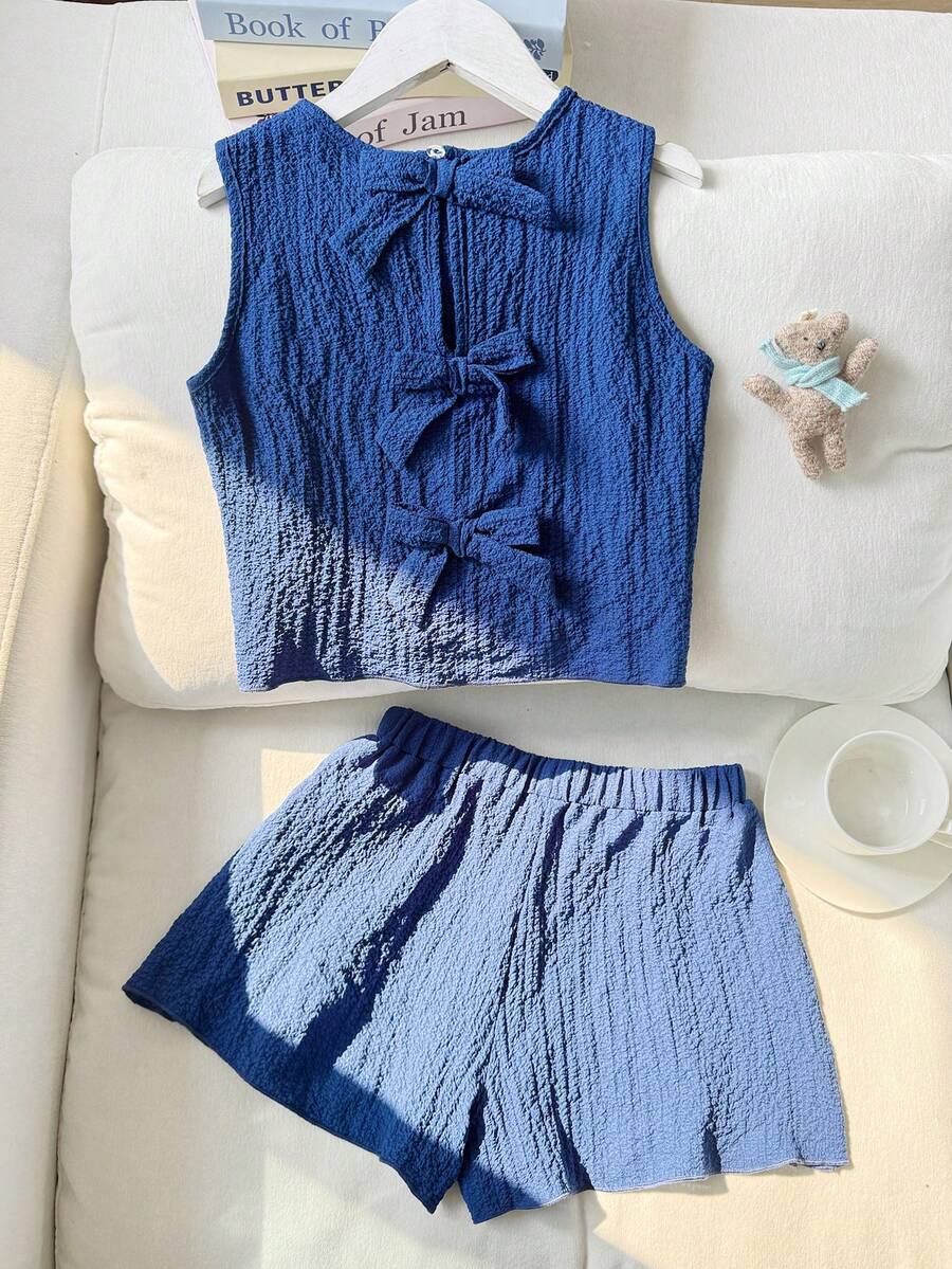 Tween girls casual blue tank top featuring round neck, textured fabric, and bow detail paired with matching shorts set.