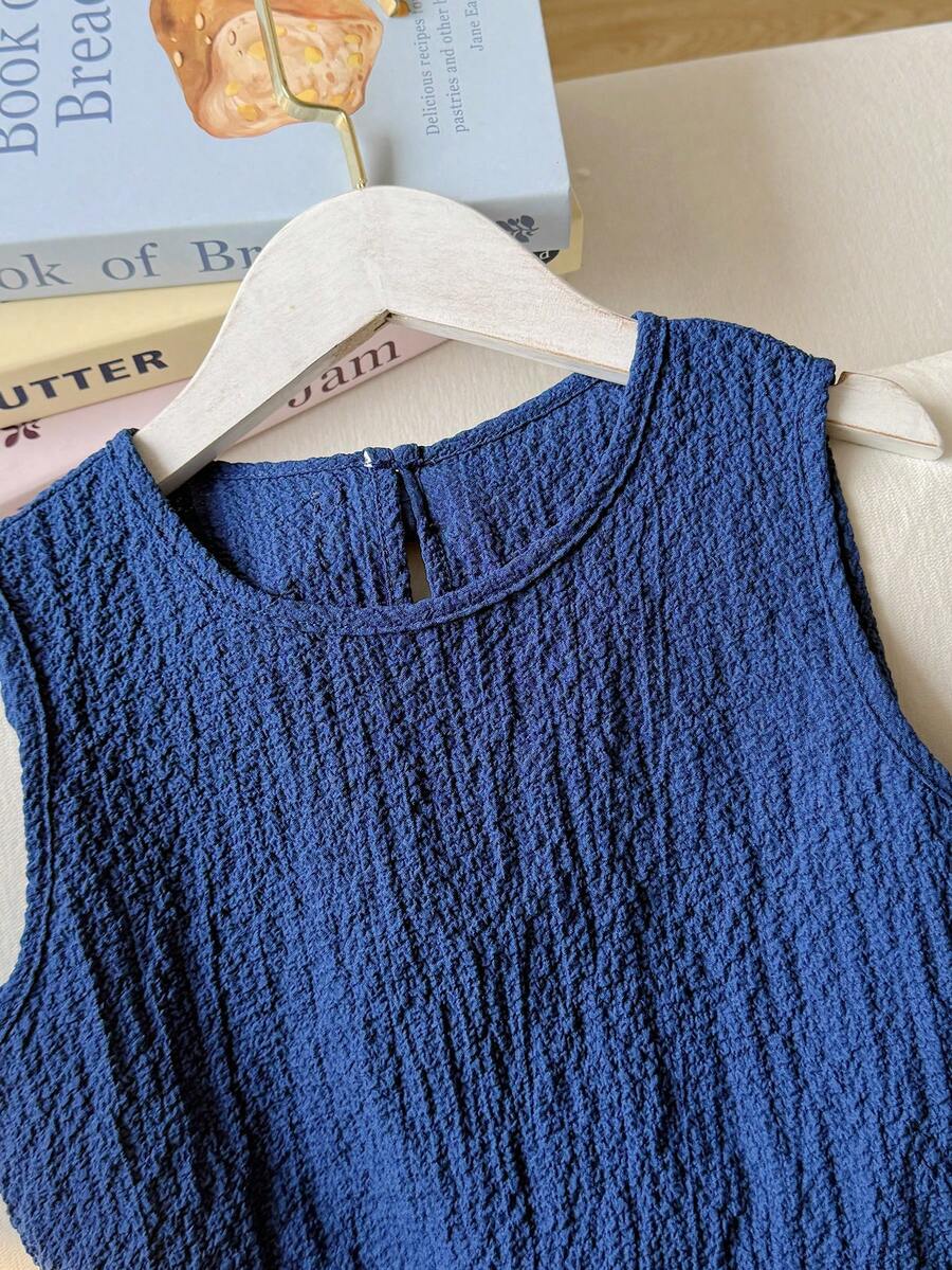 Tween girls casual blue tank top featuring round neck, textured fabric, and bow detail paired with matching shorts set.