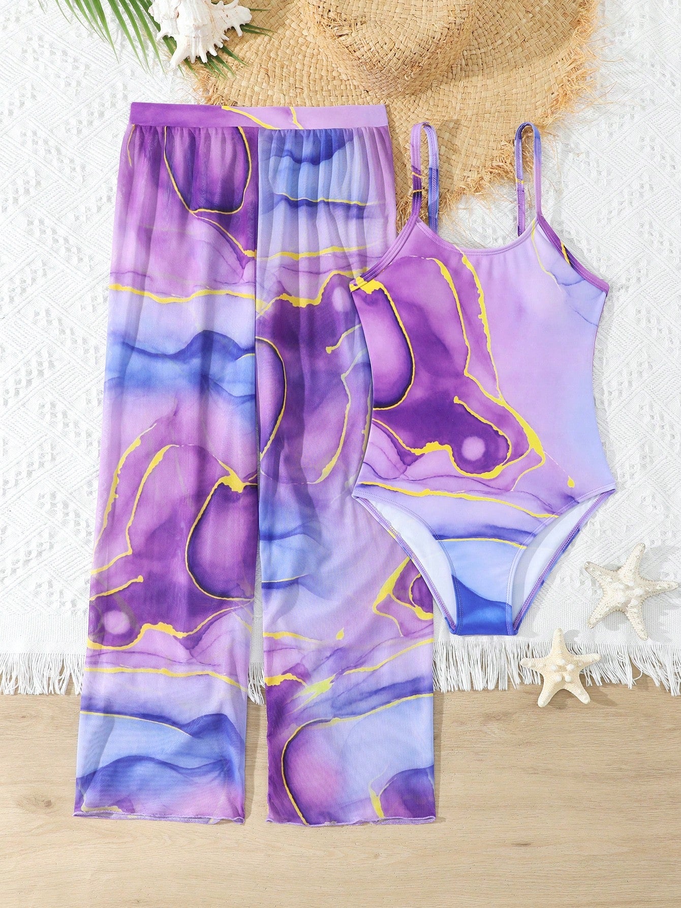 Purple tween girls one-piece swimsuit set with spaghetti straps, graphic all-over print, pocket detail, and matching long pants for beach or pool vacation wear.